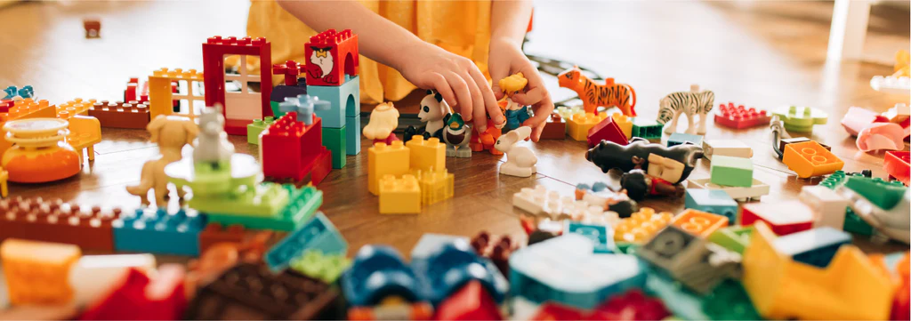 Close up of hands manipulating bricks for kinaesthetic learning.