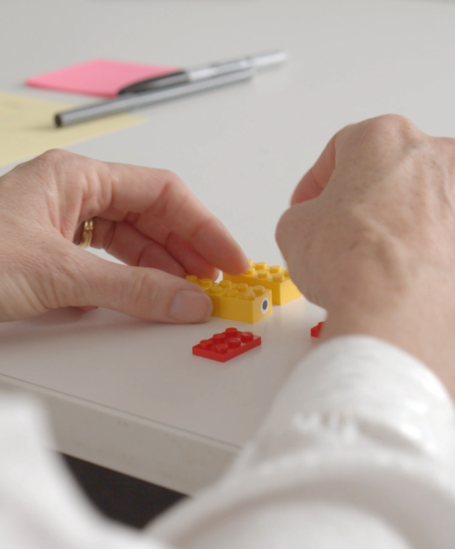 Fifteen unique minifigs laid out on a white table