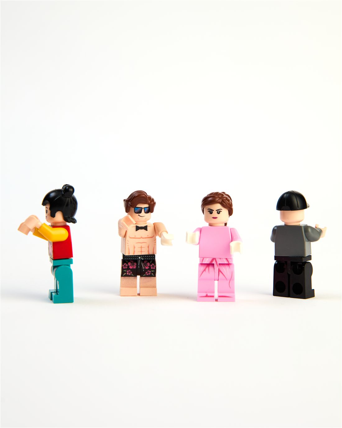 Four different minifigs standing in a row